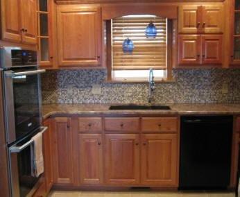 Finished kitchen 4 - Maple cabinets with small tile backsplash behind kitchen sink. 
