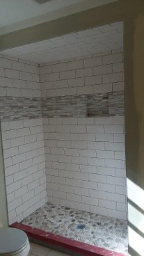 Walk-in tile shower with ceiling tile