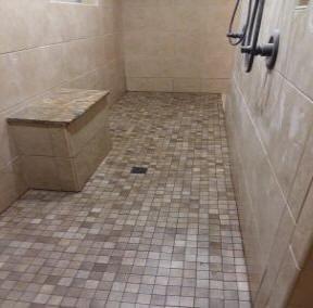 Large walk-in shower with large and small tiles